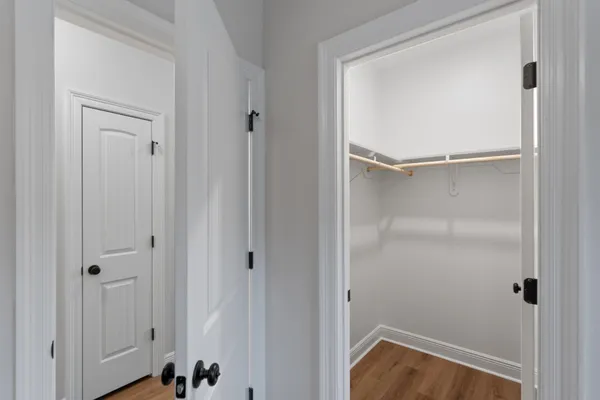 a bathroom with a toilet a sink a mirror and vanity