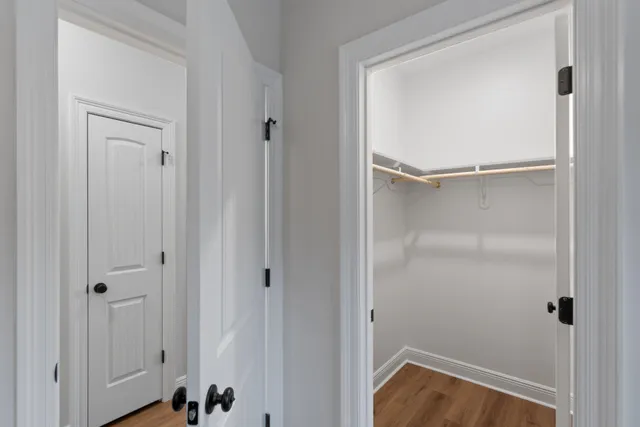 a bathroom with a toilet a sink a mirror and vanity