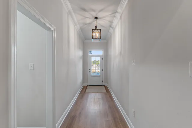 a view of wooden floor and windows in a room