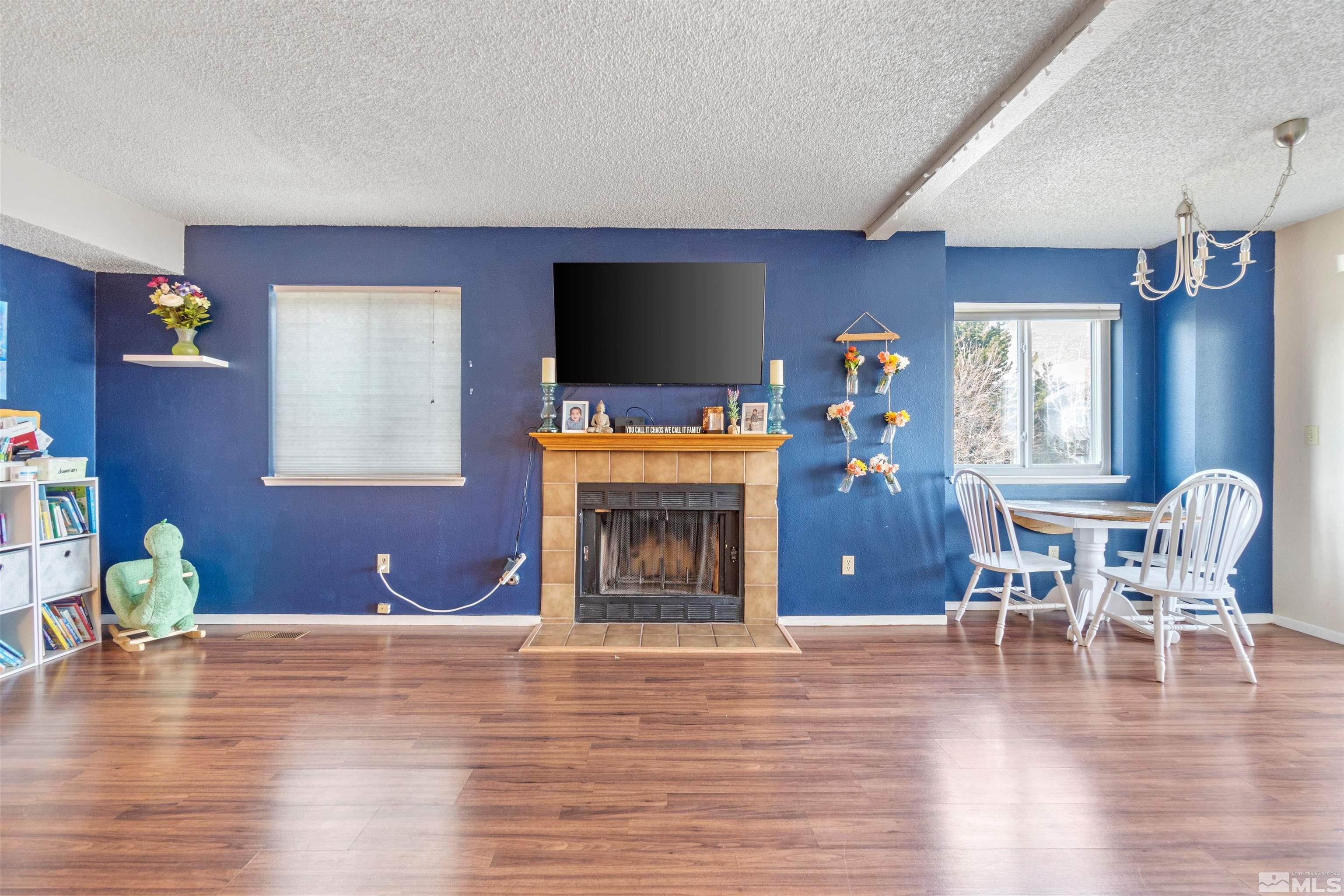 3971 Kings Row Reno, NV 89503 - Photo 11 of 29 a living room with furniture a fireplace and a flat screen tv