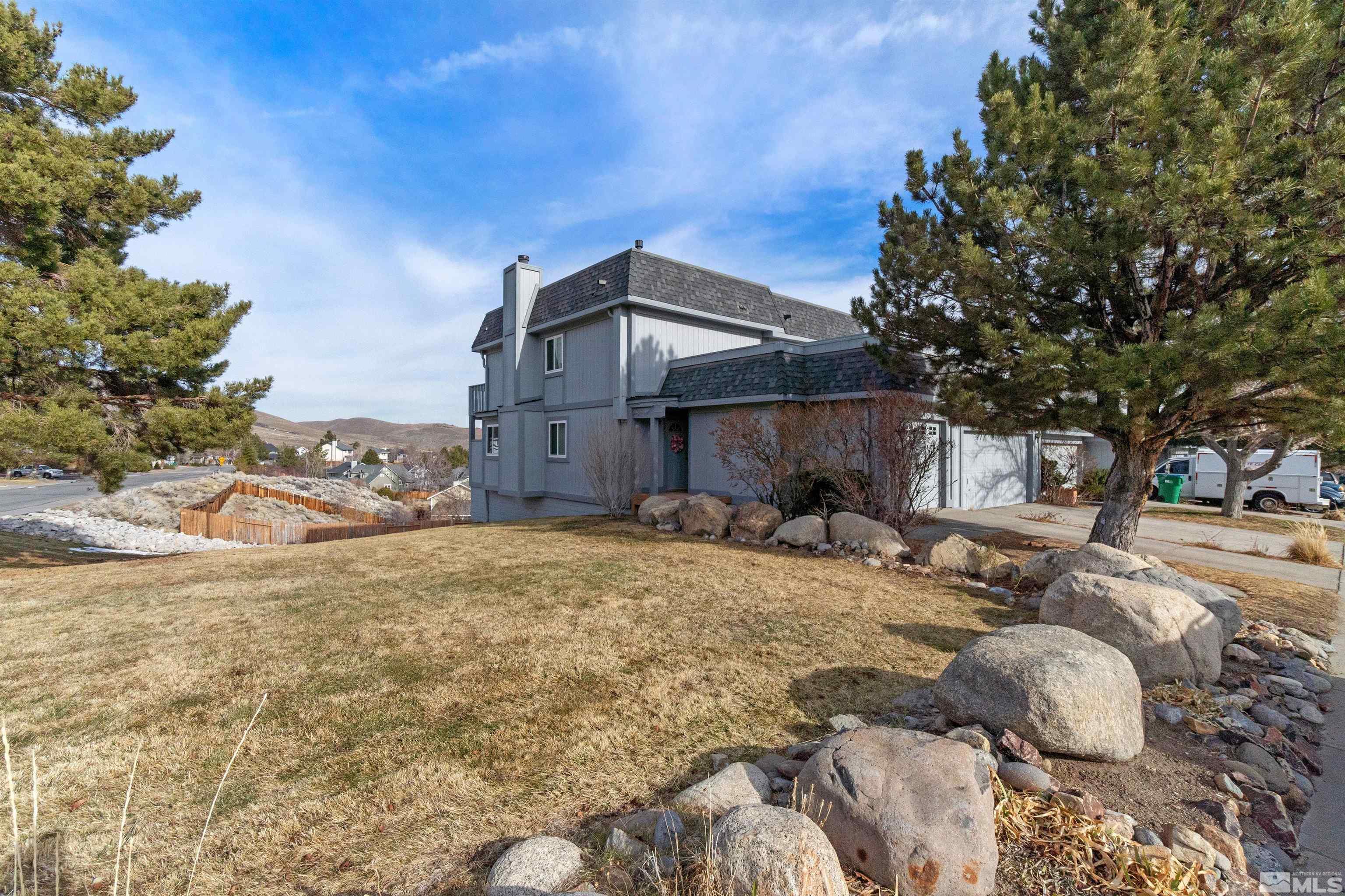 3971 Kings Row Reno, NV 89503 - Photo 2 of 29 a view of a house with large trees and covered with snow in the background