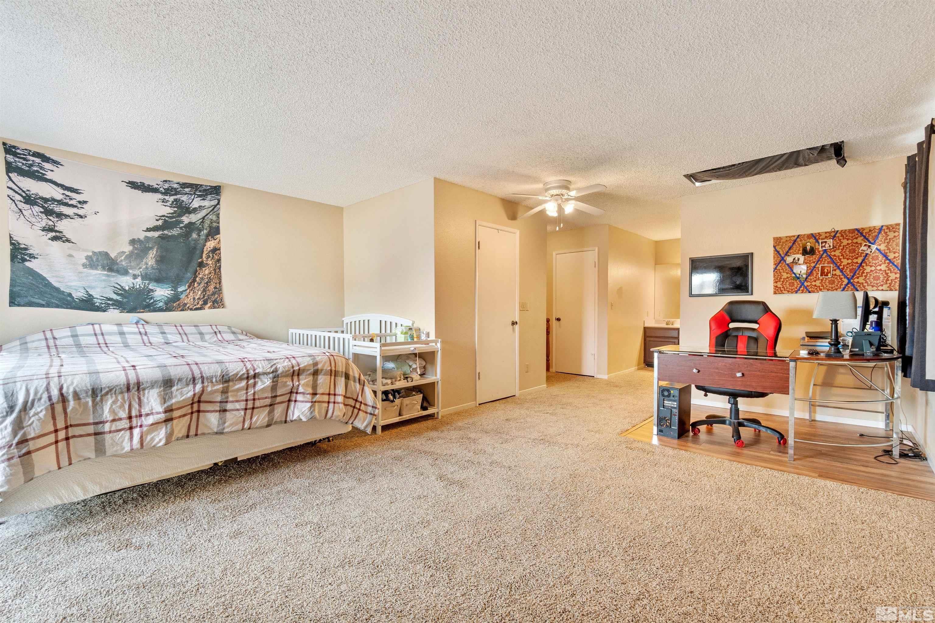 3971 Kings Row Reno, NV 89503 - Photo 26 of 29 a bedroom with furniture and a chandelier