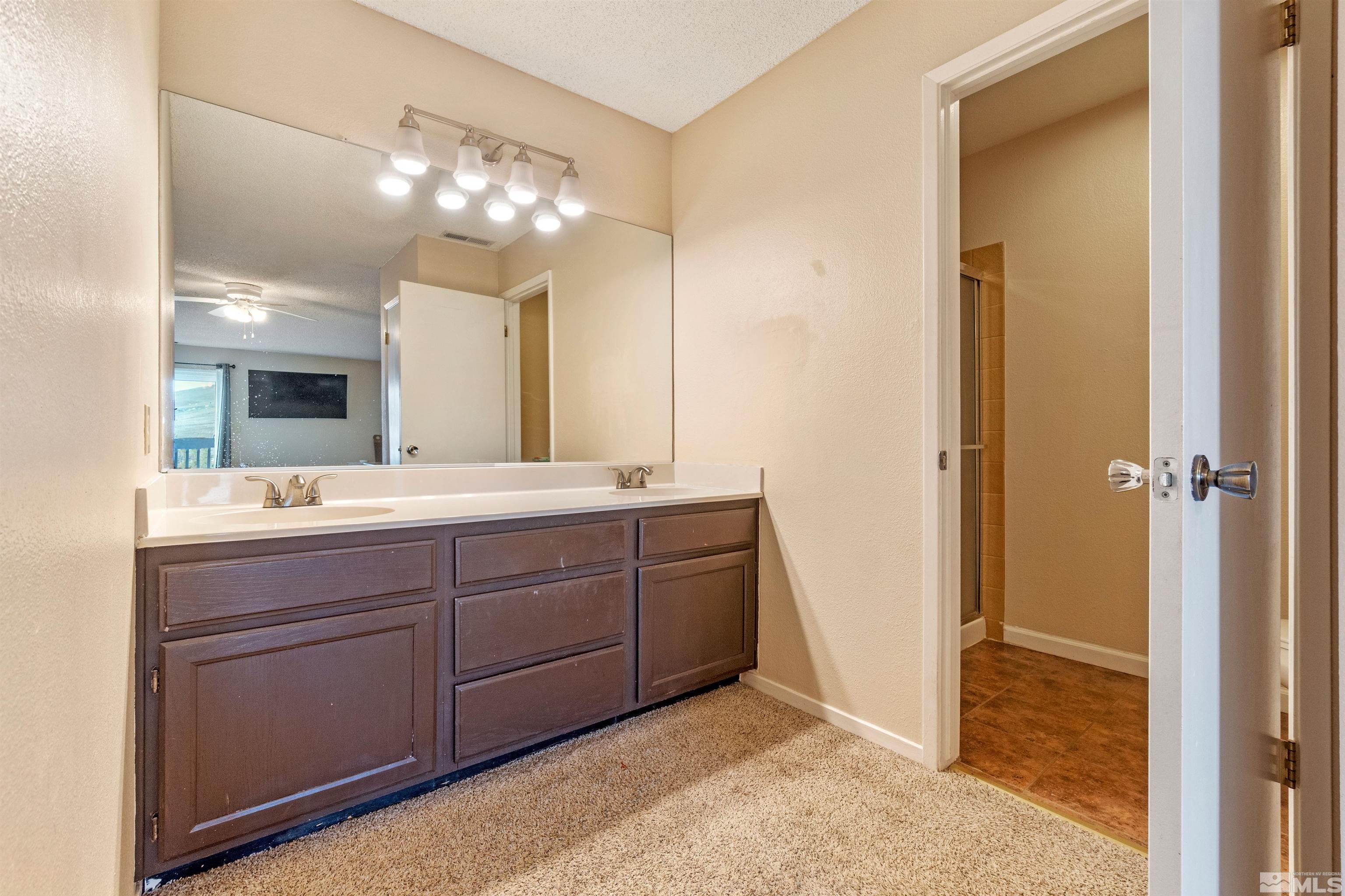 3971 Kings Row Reno, NV 89503 - Photo 27 of 29 a bathroom with a sink vanity and a mirror
