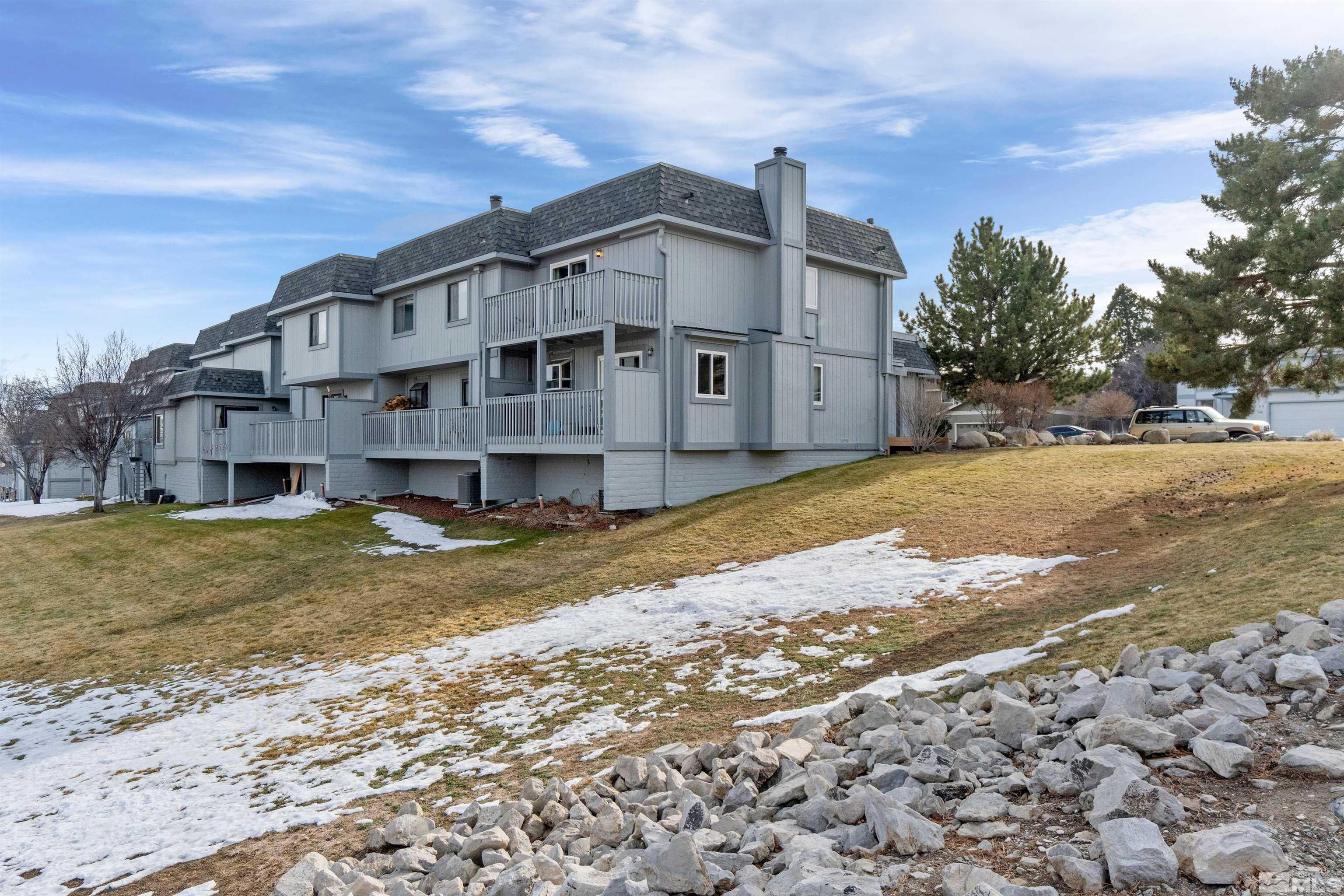 3971 Kings Row Reno, NV 89503 - Photo 3 of 29 a view of a big house with a big yard and large trees