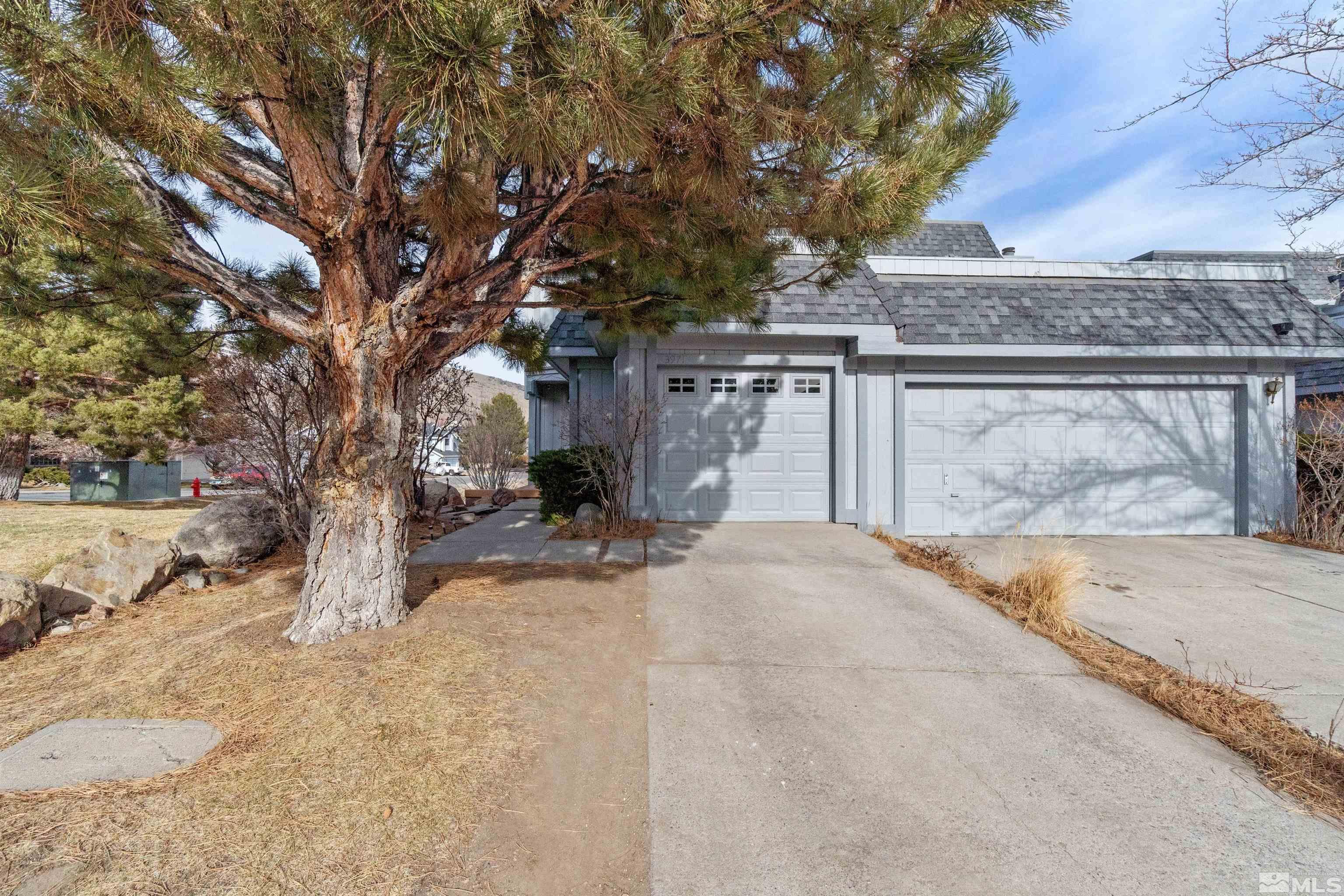 3971 Kings Row Reno, NV 89503 - Photo 4 of 29 front view of a house with a yard and trees