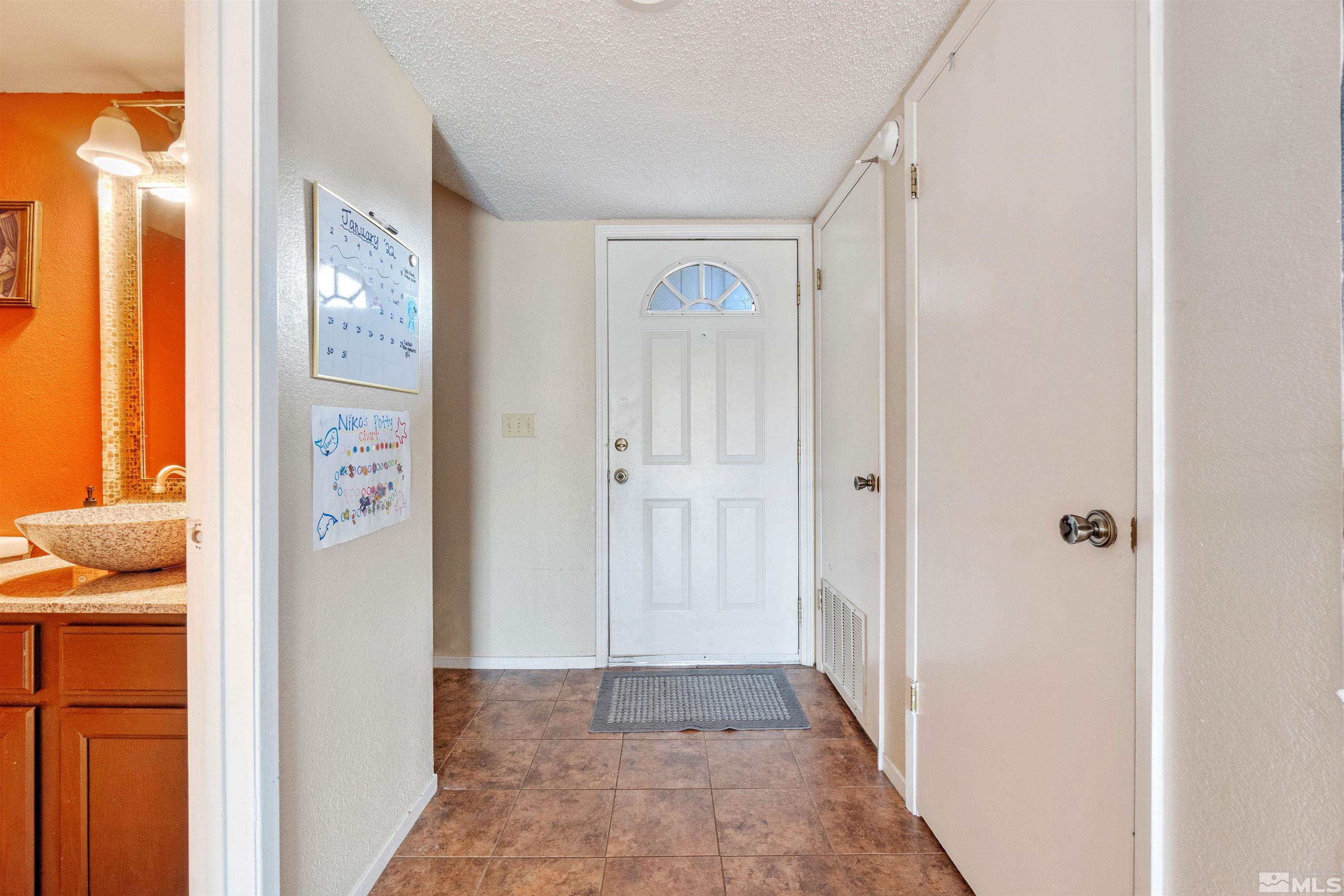 3971 Kings Row Reno, NV 89503 - Photo 6 of 29 a view of a hallway with windows and closet