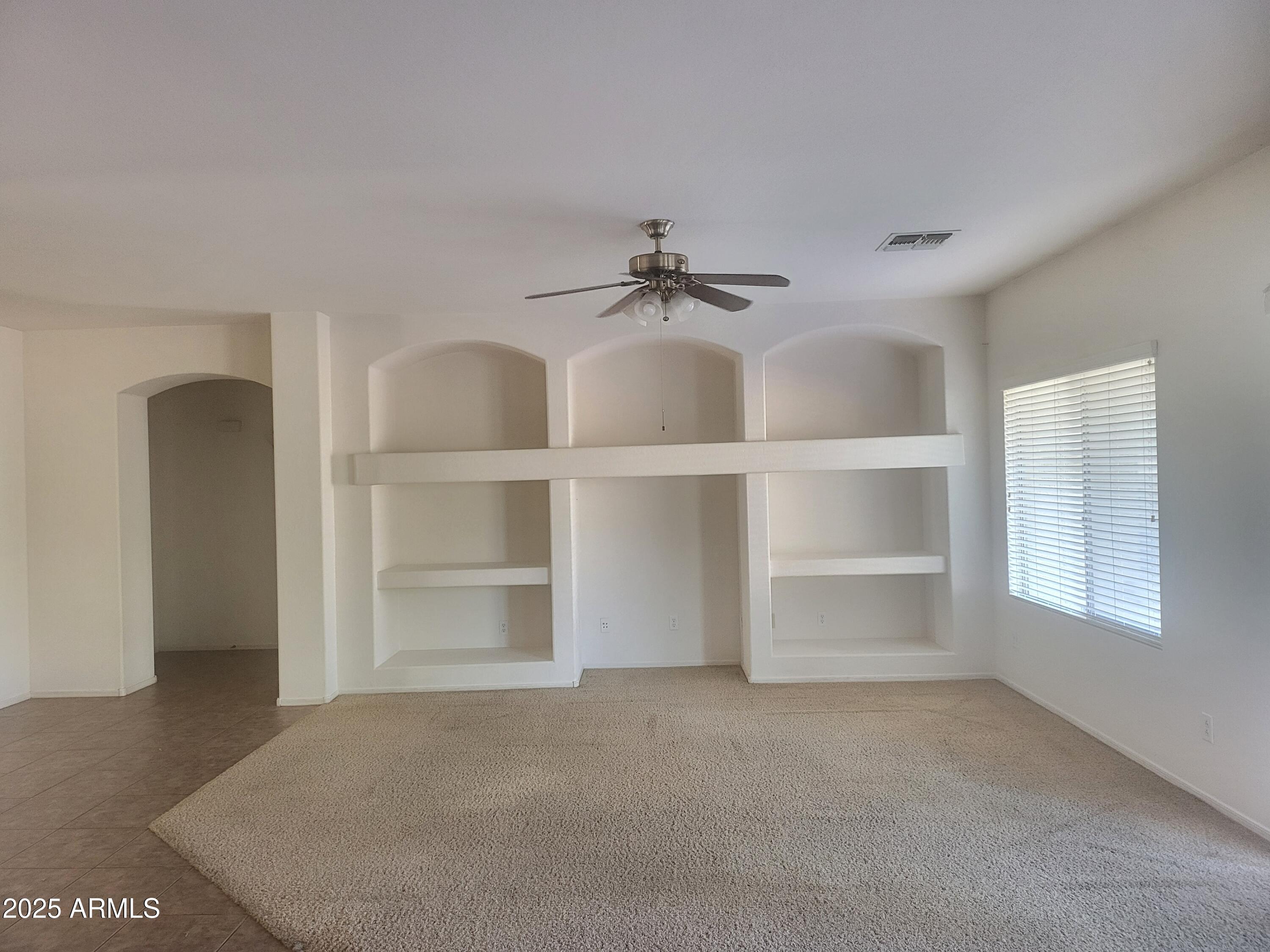 1388 East Boston Street Gilbert, AZ 85295 - Photo 4 of 13 a view of a room with a cabinet and a ceiling fan