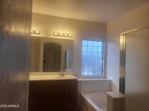 a bathroom with a bathtub a sink and a window
