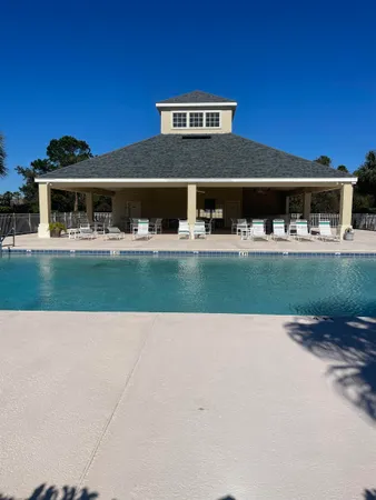 a view of swimming pool with outdoor seating and plants