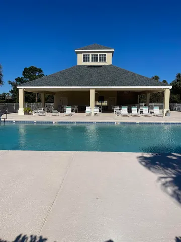 a view of swimming pool with outdoor seating and plants