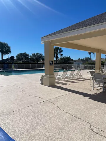 a view of a yard in front of a house with a large trees