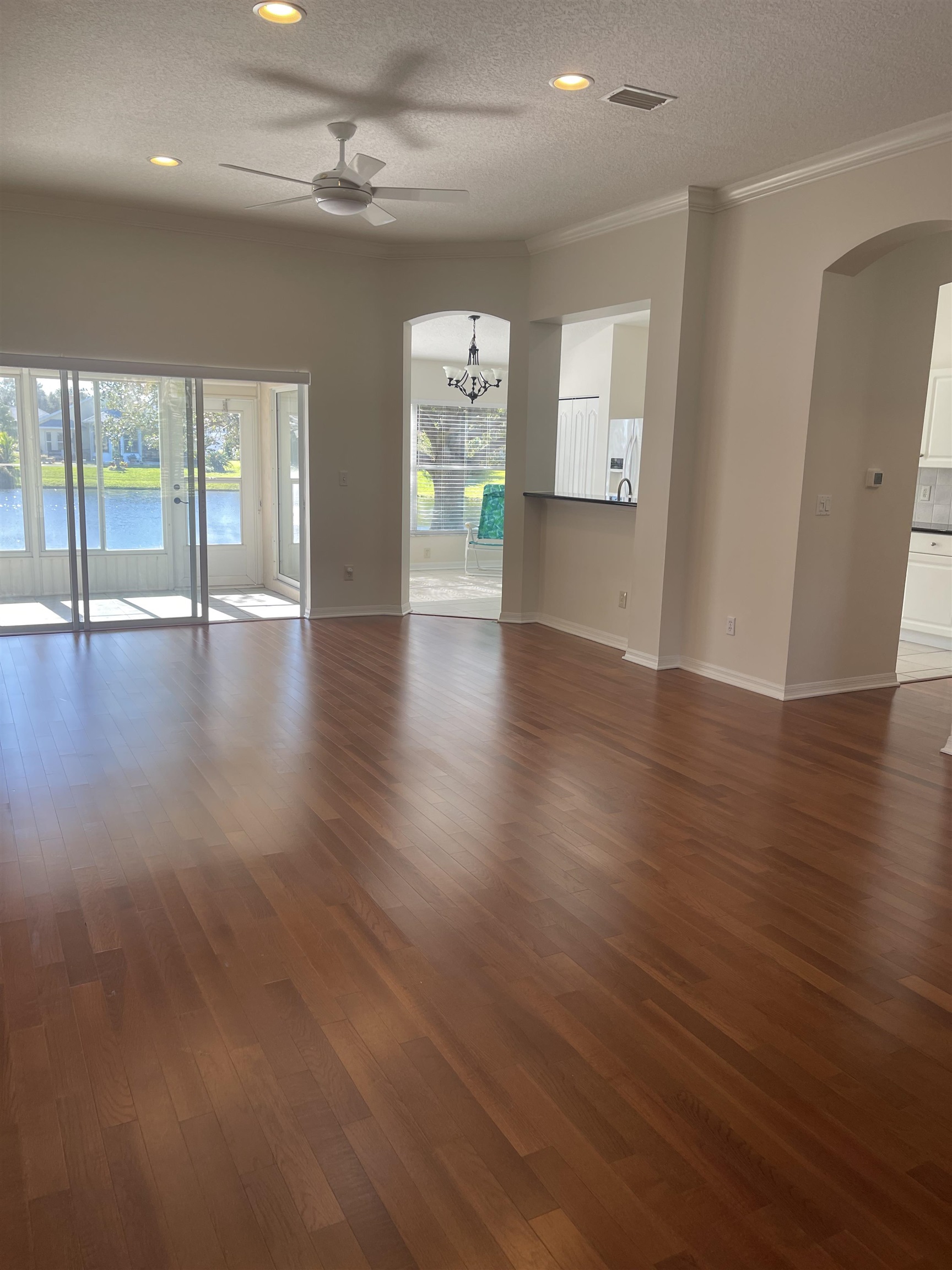 1113 Compass Row St. Augustine, FL 32080 - Photo 4 of 29 an empty room with wooden floor and windows