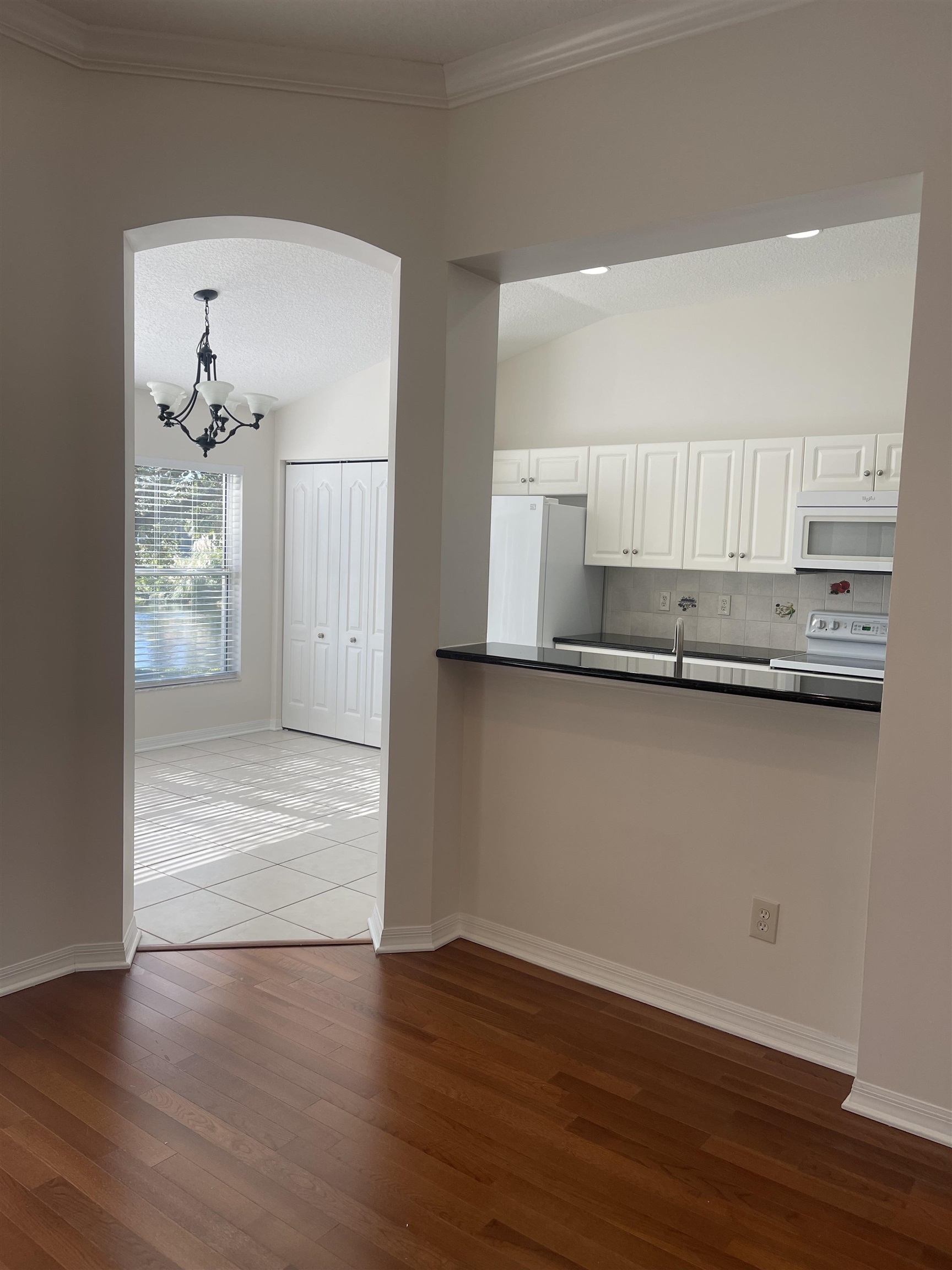 1113 Compass Row St. Augustine, FL 32080 - Photo 6 of 29 a view of kitchen with granite countertop cabinets and wooden floor