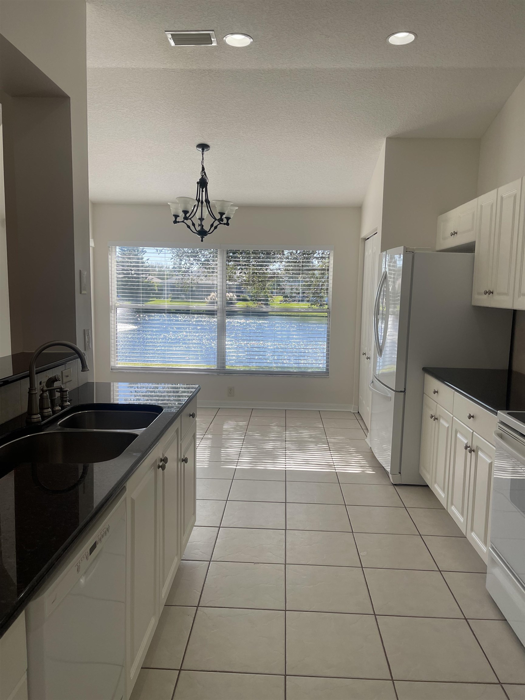 1113 Compass Row St. Augustine, FL 32080 - Photo 9 of 29 a kitchen with a sink a counter top space cabinets and stainless steel appliances