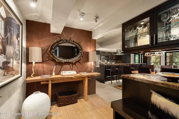 a living room with stainless steel appliances kitchen island a table and chairs