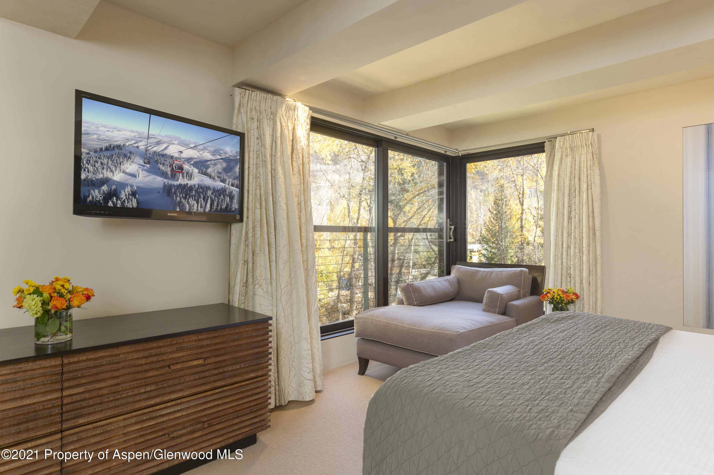 1034 East Cooper Avenue, Unit 26 Aspen, CO 81611 - Photo 16 of 23 a bedroom with furniture and next to a window