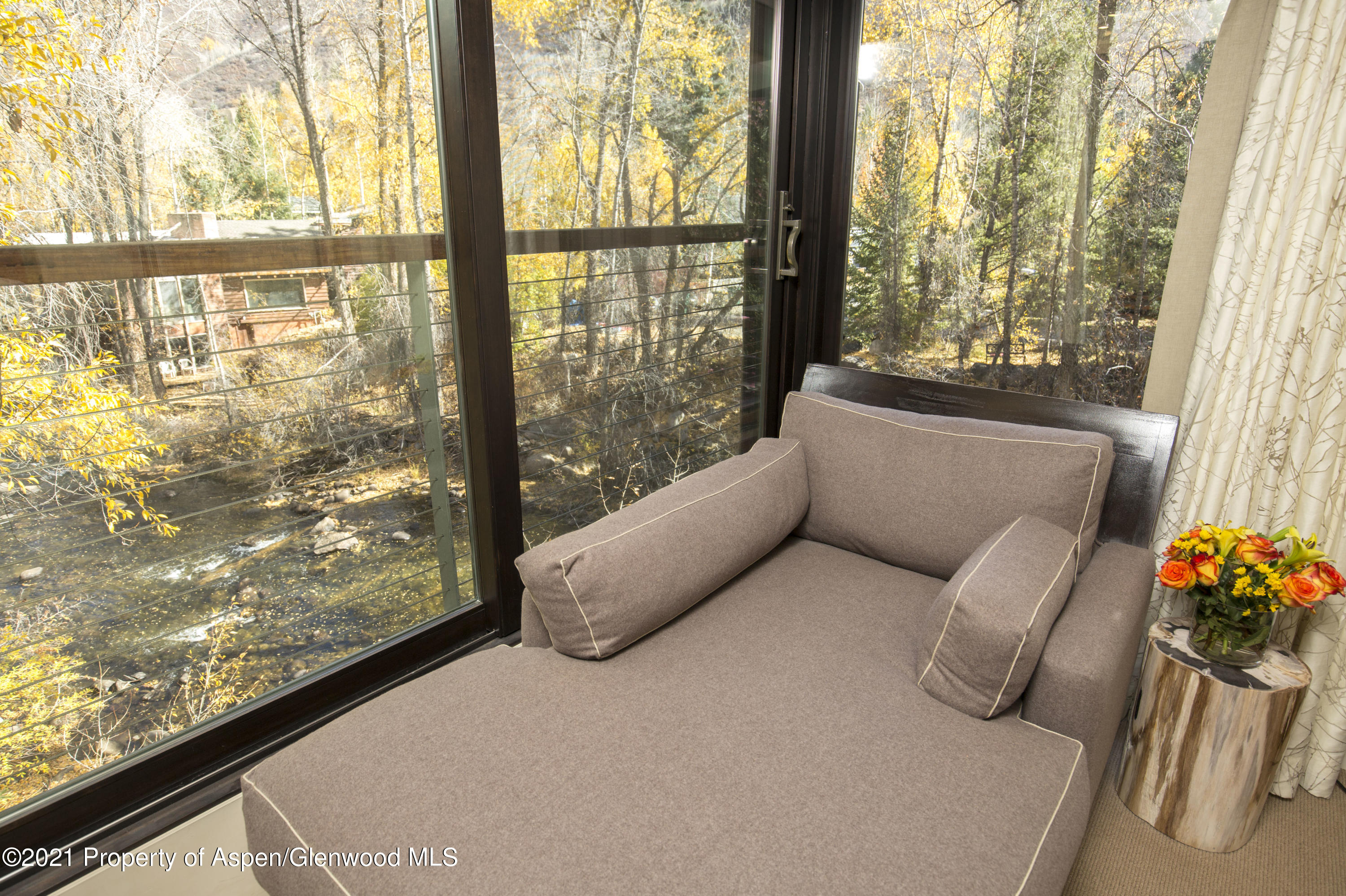 1034 East Cooper Avenue, Unit 26 Aspen, CO 81611 - Photo 17 of 23 a bedroom with furniture and a large window