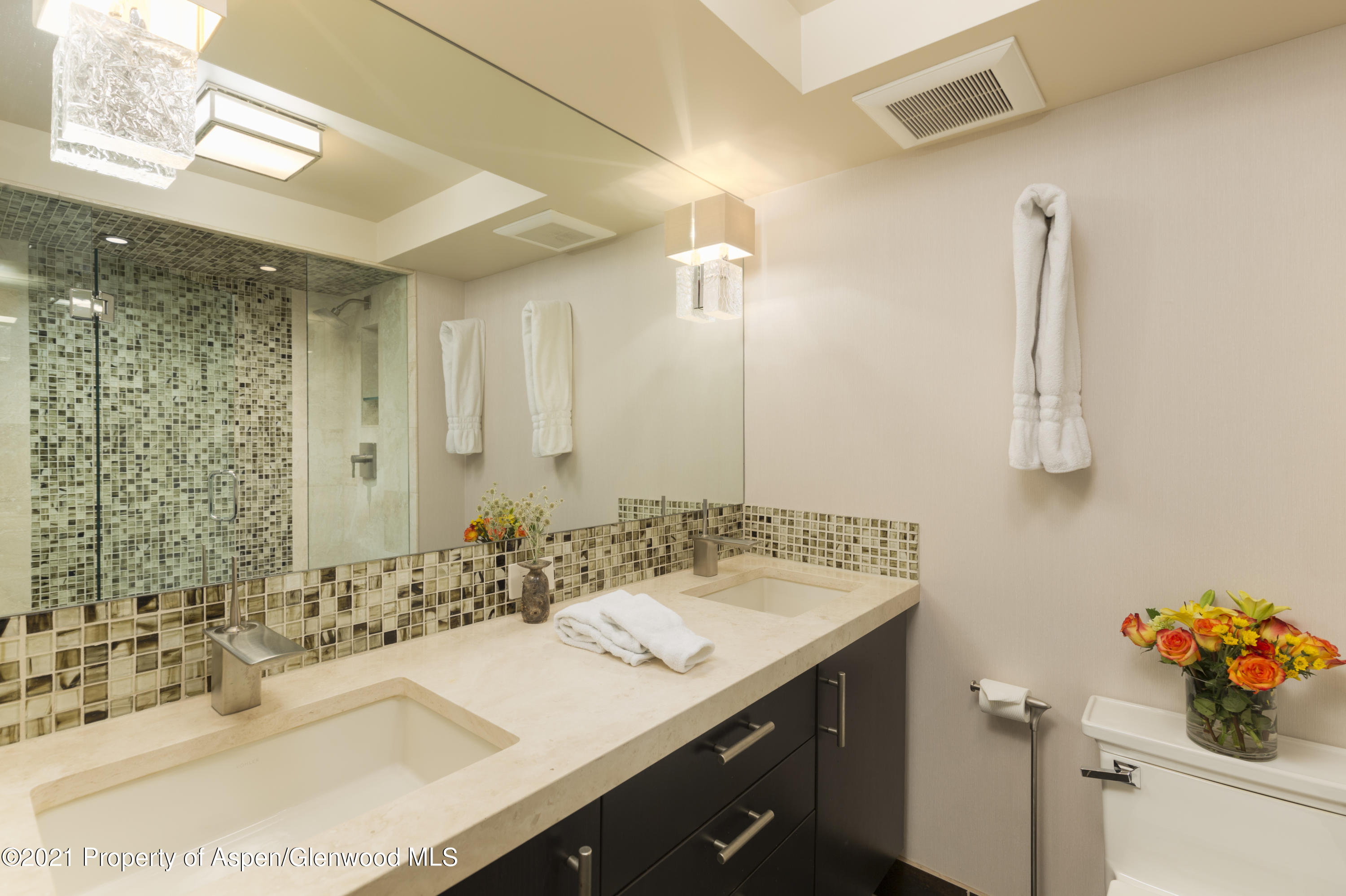 1034 East Cooper Avenue, Unit 26 Aspen, CO 81611 - Photo 21 of 23 a bathroom with a sink vanity and a mirror