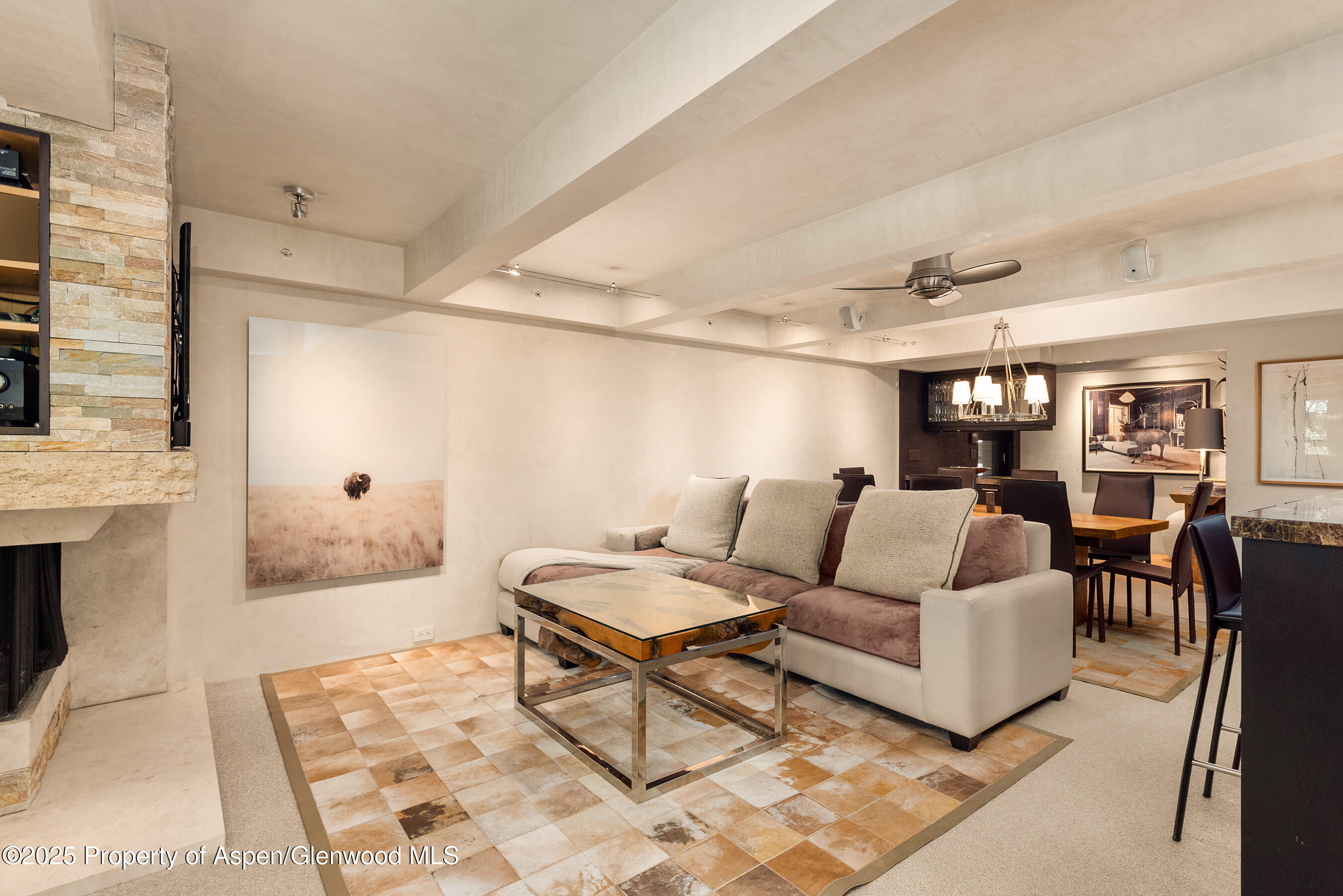 1034 East Cooper Avenue, Unit 26 Aspen, CO 81611 - Photo 3 of 23 a living room with furniture and wooden floor