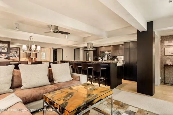 a living room with furniture and kitchen view
