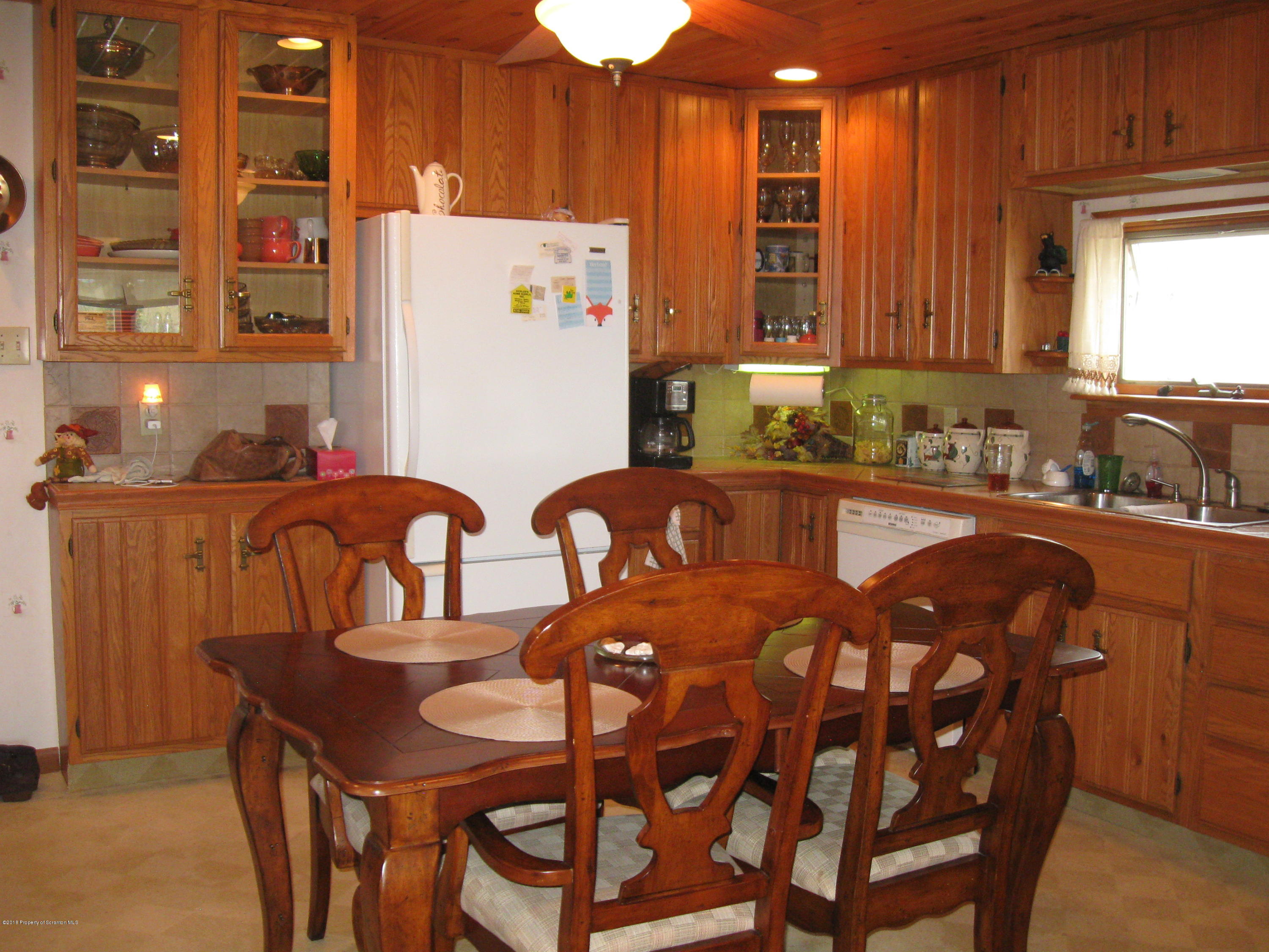 2744 State Rte 3013 Springville, PA 18844 - Photo 12 of 46 a kitchen with a table chairs sink and cabinets