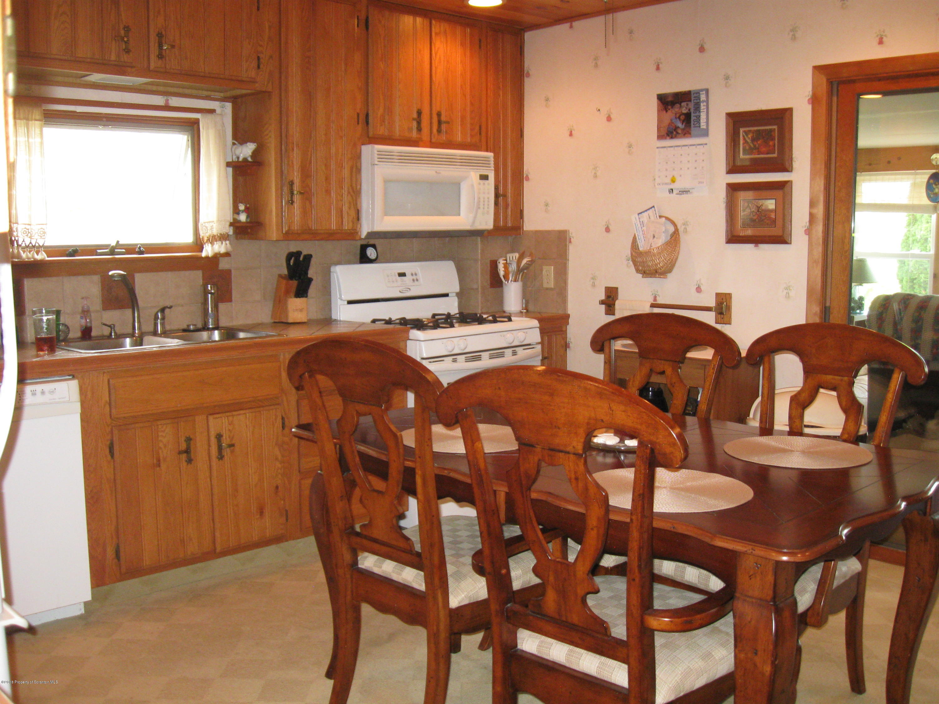 2744 State Rte 3013 Springville, PA 18844 - Photo 13 of 46 a kitchen with stainless steel appliances granite countertop a dining table and chairs