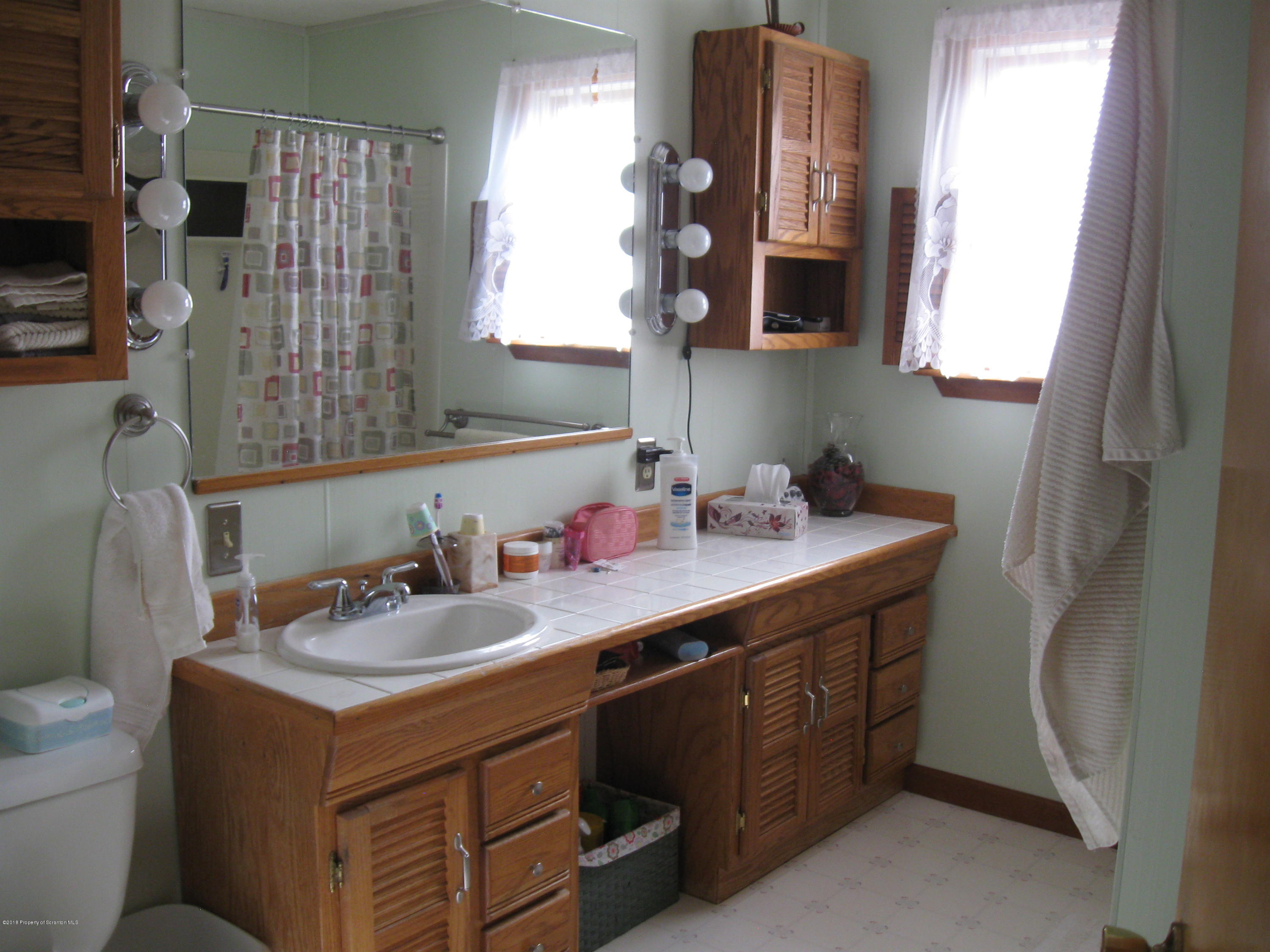2744 State Rte 3013 Springville, PA 18844 - Photo 19 of 46 a bathroom with a sink double vanity and a mirror