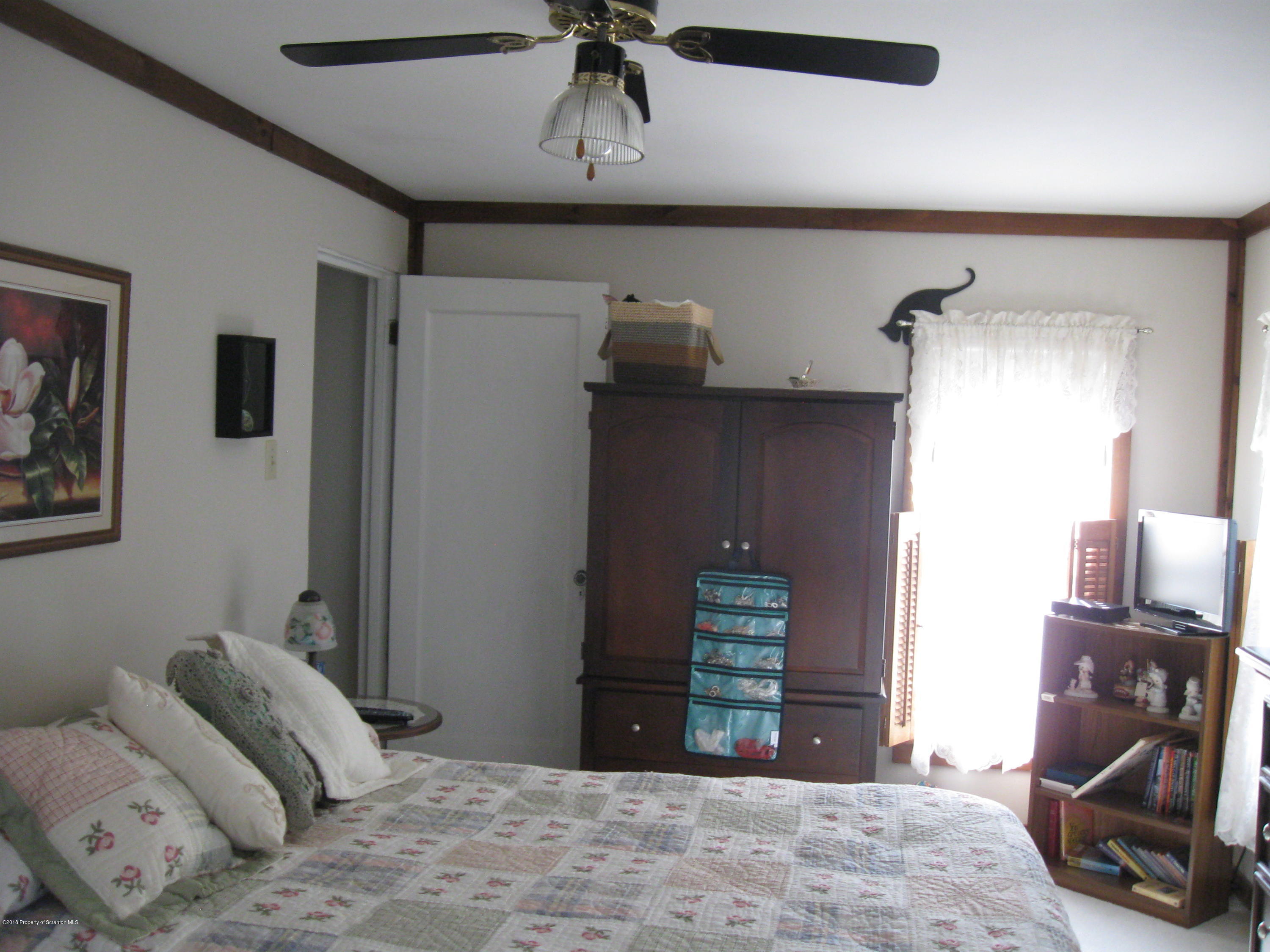 2744 State Rte 3013 Springville, PA 18844 - Photo 25 of 46 a bedroom with a bed and a chandelier