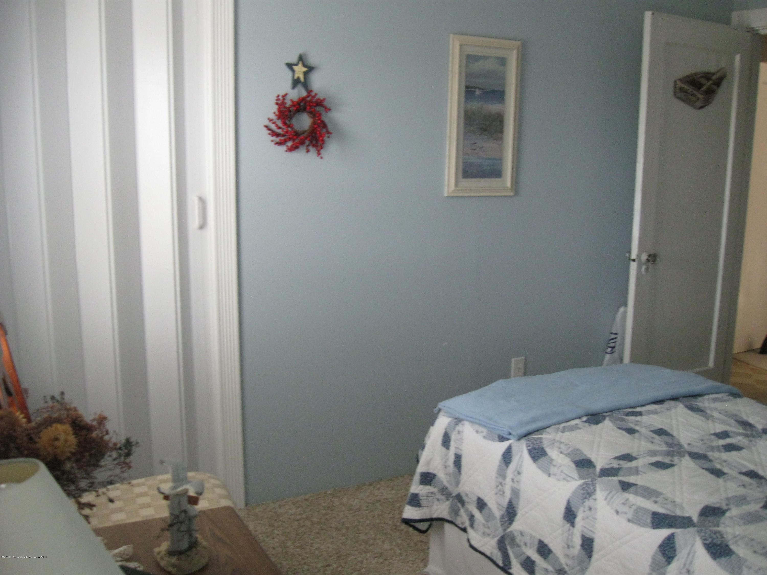 2744 State Rte 3013 Springville, PA 18844 - Photo 29 of 46 a bedroom with a bed and a chandelier