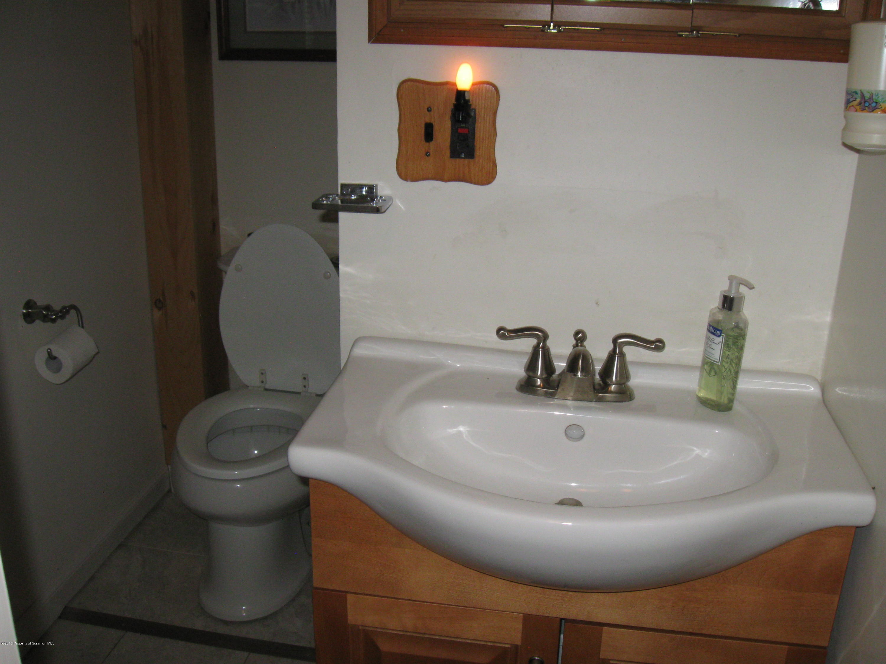 2744 State Rte 3013 Springville, PA 18844 - Photo 31 of 46 a bathroom with a toilet and a sink