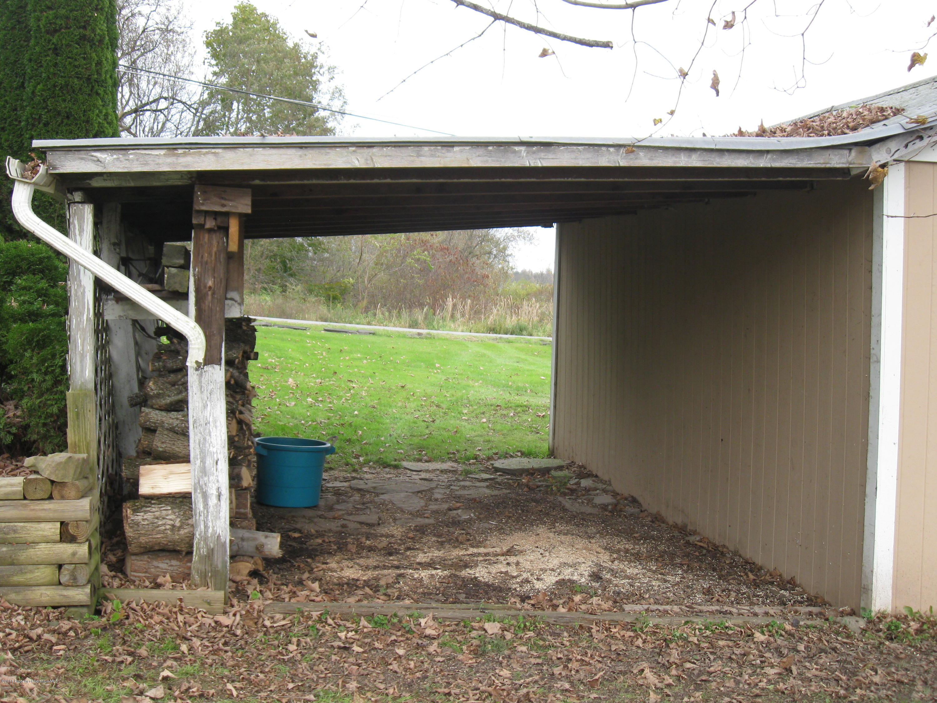 2744 State Rte 3013 Springville, PA 18844 - Photo 41 of 46 a backyard of a house with a fountain and porch