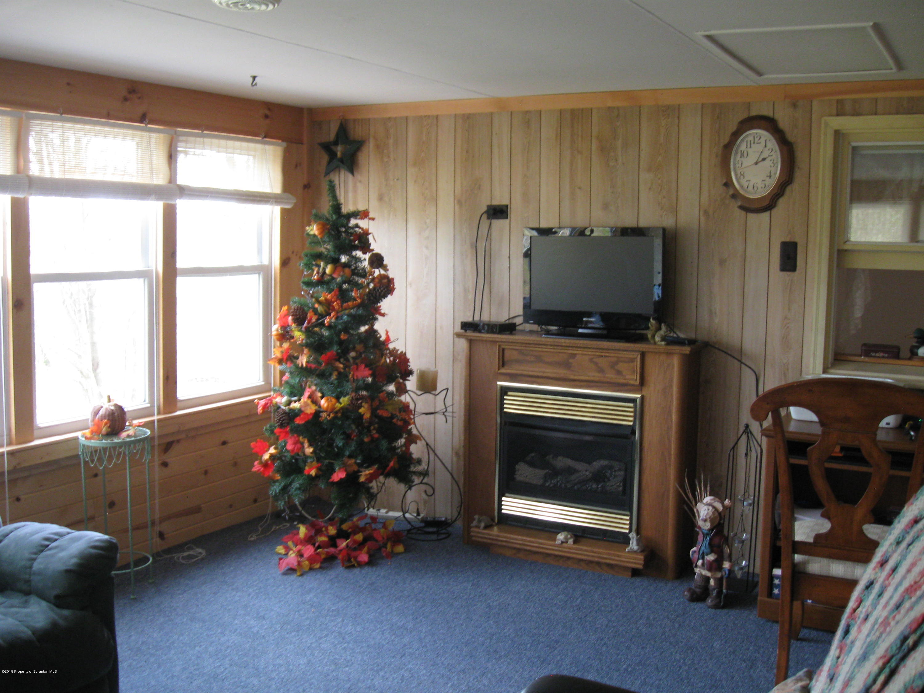 2744 State Rte 3013 Springville, PA 18844 - Photo 10 of 46 a living room with furniture and a fireplace