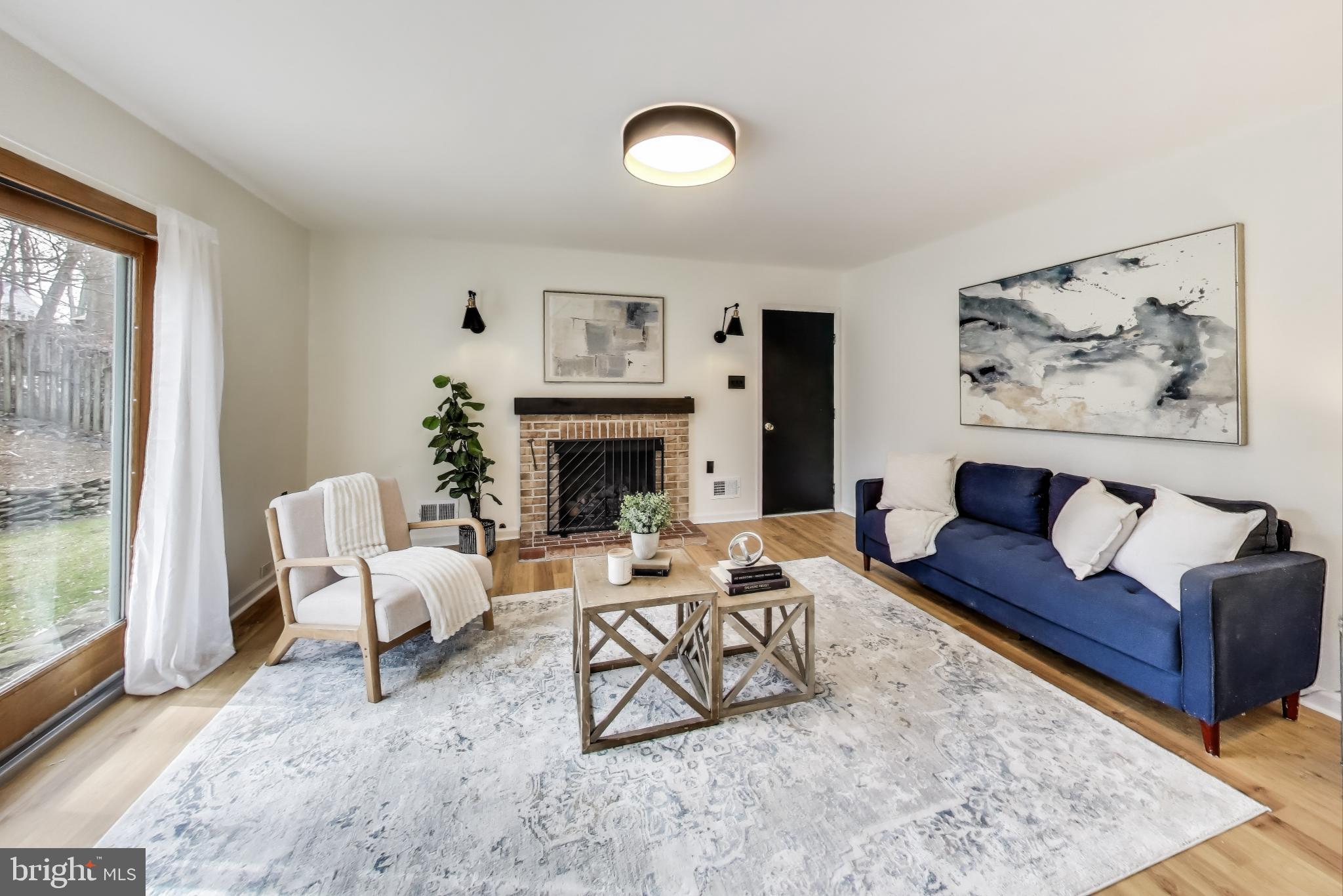 9023 Brook Ford Road Burke, VA 22015 - Photo 13 of 43 a living room with furniture and a fireplace