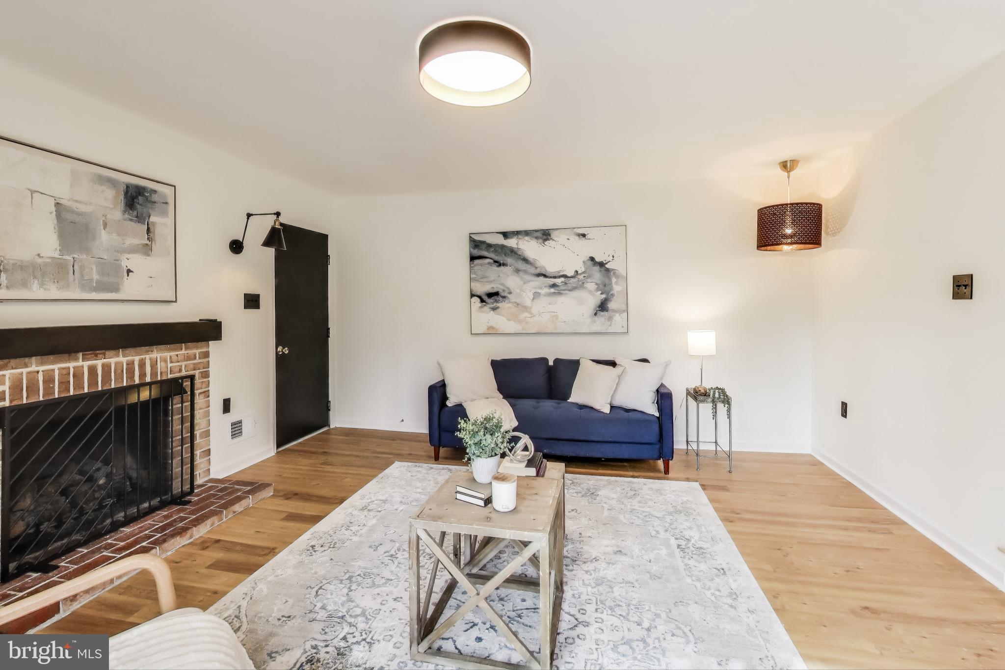 9023 Brook Ford Road Burke, VA 22015 - Photo 15 of 43 a living room with furniture and a fireplace