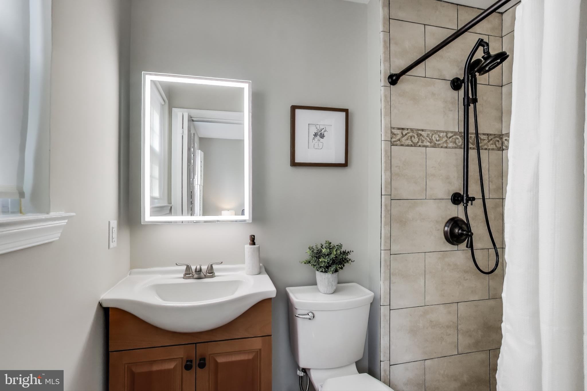 9023 Brook Ford Road Burke, VA 22015 - Photo 22 of 43 a bathroom with a sink toilet and shower