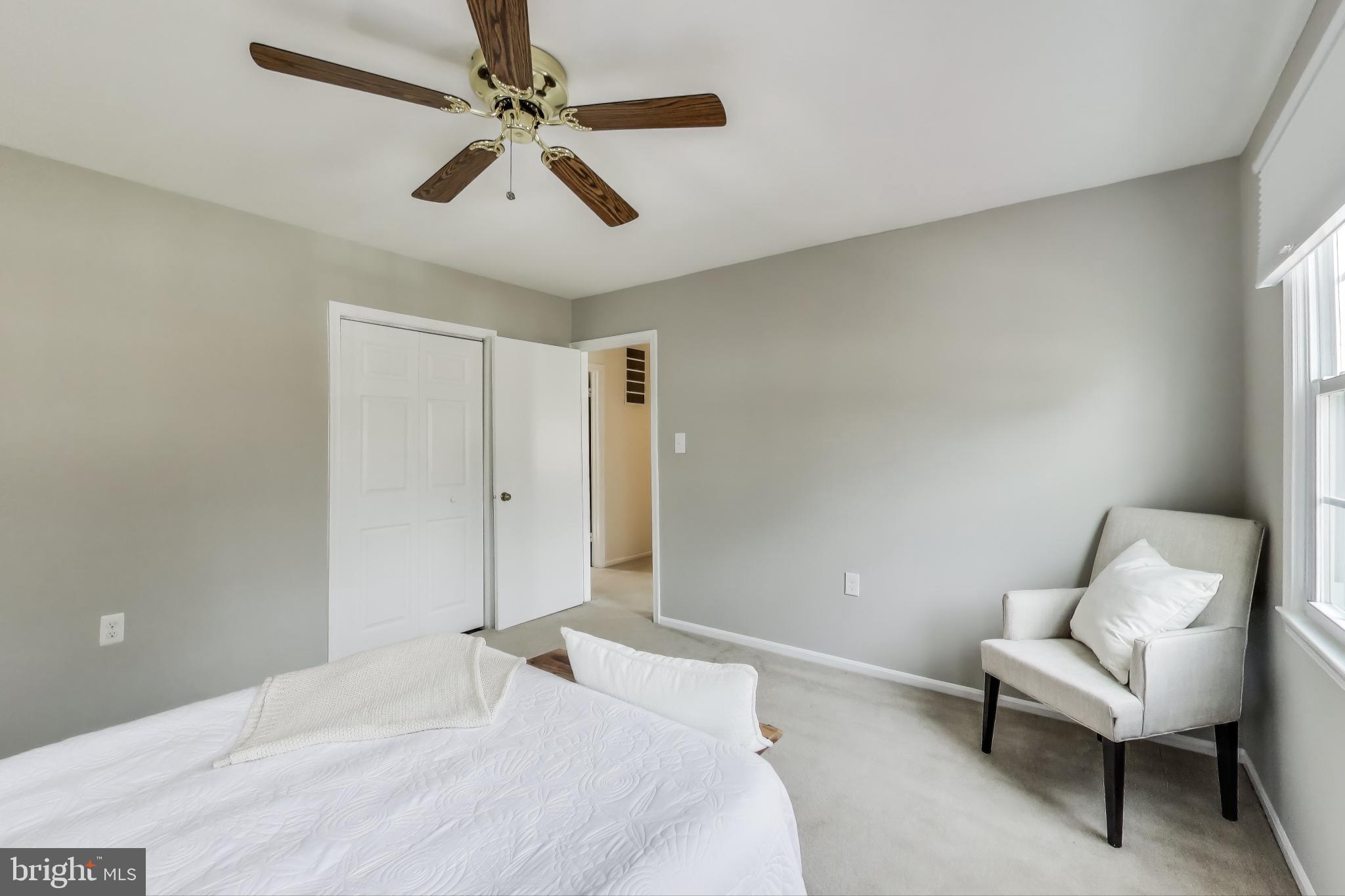 9023 Brook Ford Road Burke, VA 22015 - Photo 24 of 43 a bedroom with a bed and a chair