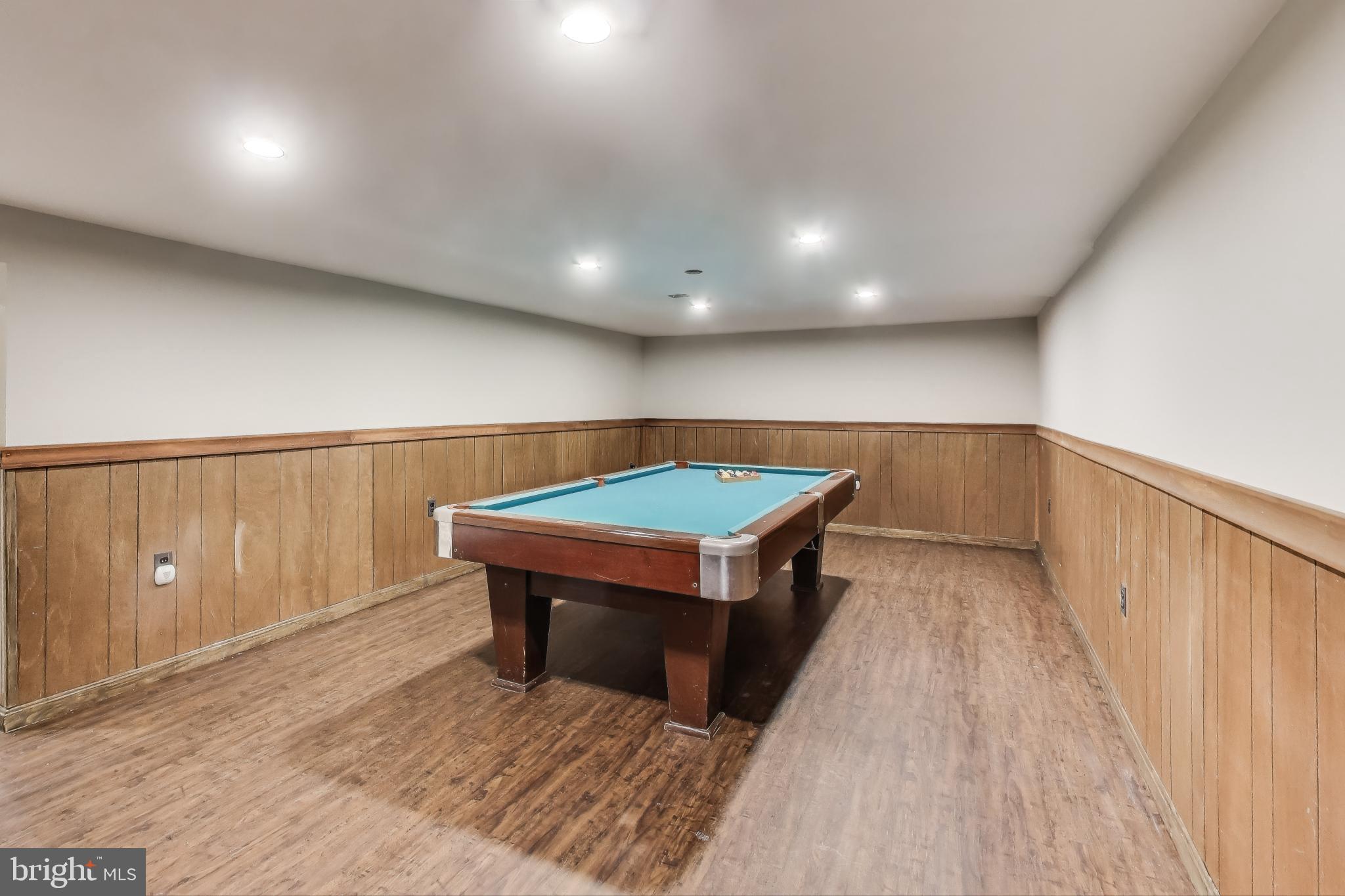 9023 Brook Ford Road Burke, VA 22015 - Photo 31 of 43 a room with wooden floor and furniture