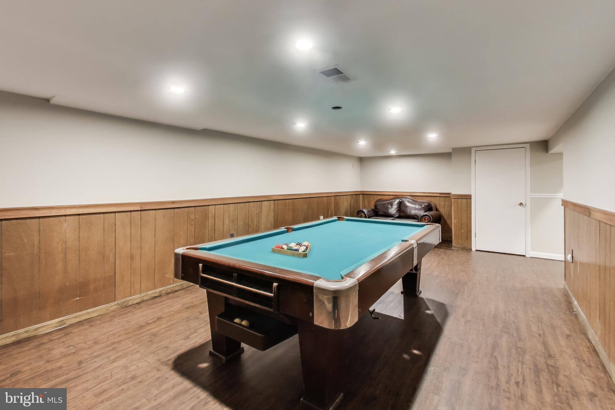 9023 Brook Ford Road Burke, VA 22015 - Photo 32 of 43 a room with furniture and wooden floor