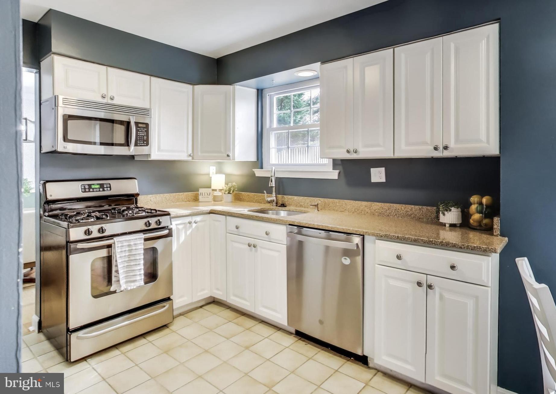 9023 Brook Ford Road Burke, VA 22015 - Photo 8 of 43 a kitchen with cabinets appliances a sink and a window