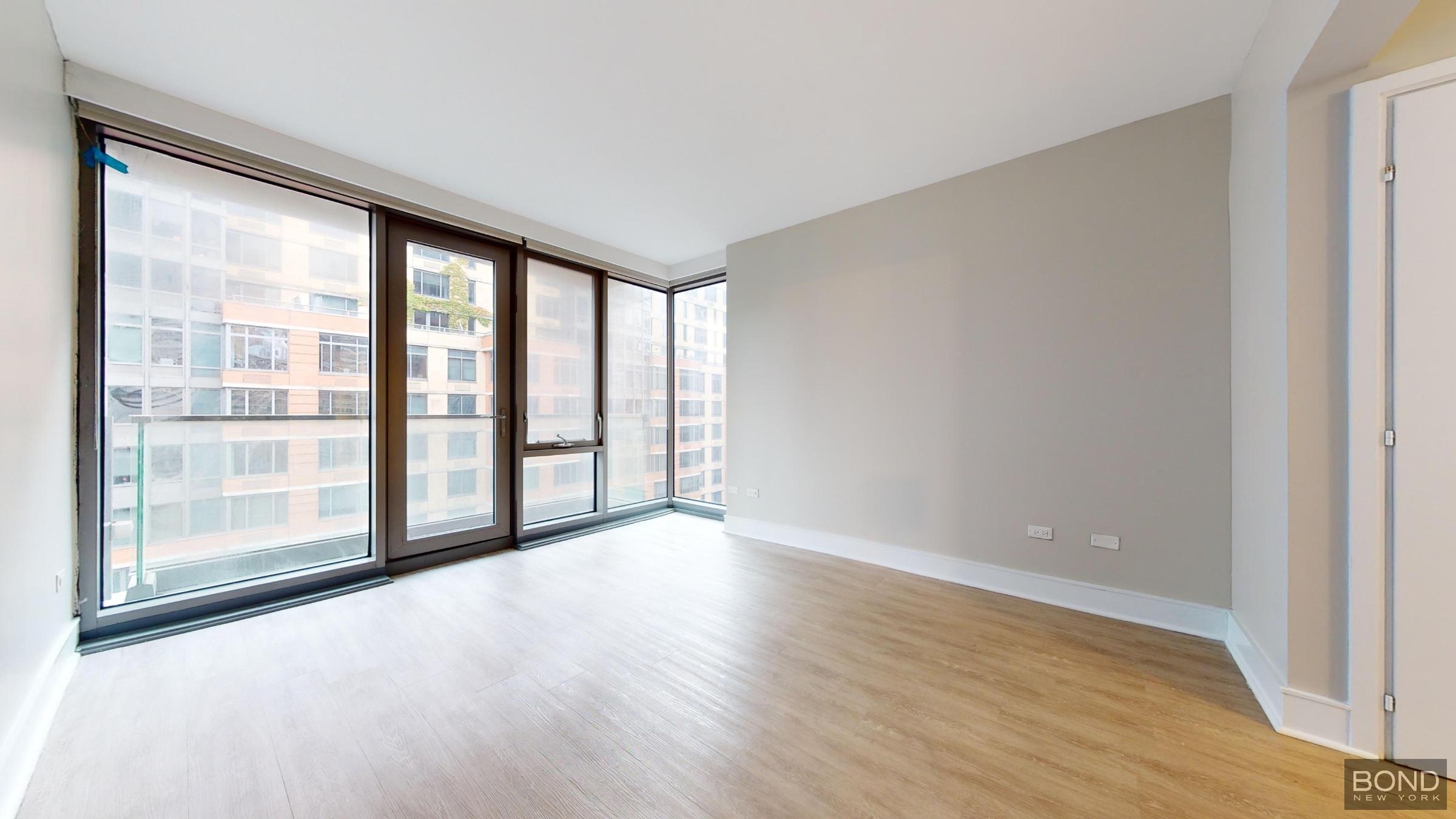 237 East 34th Street, Unit 1503 Manhattan, NY 10016 - Photo 11 of 24 a view of an empty room with wooden floor and a window