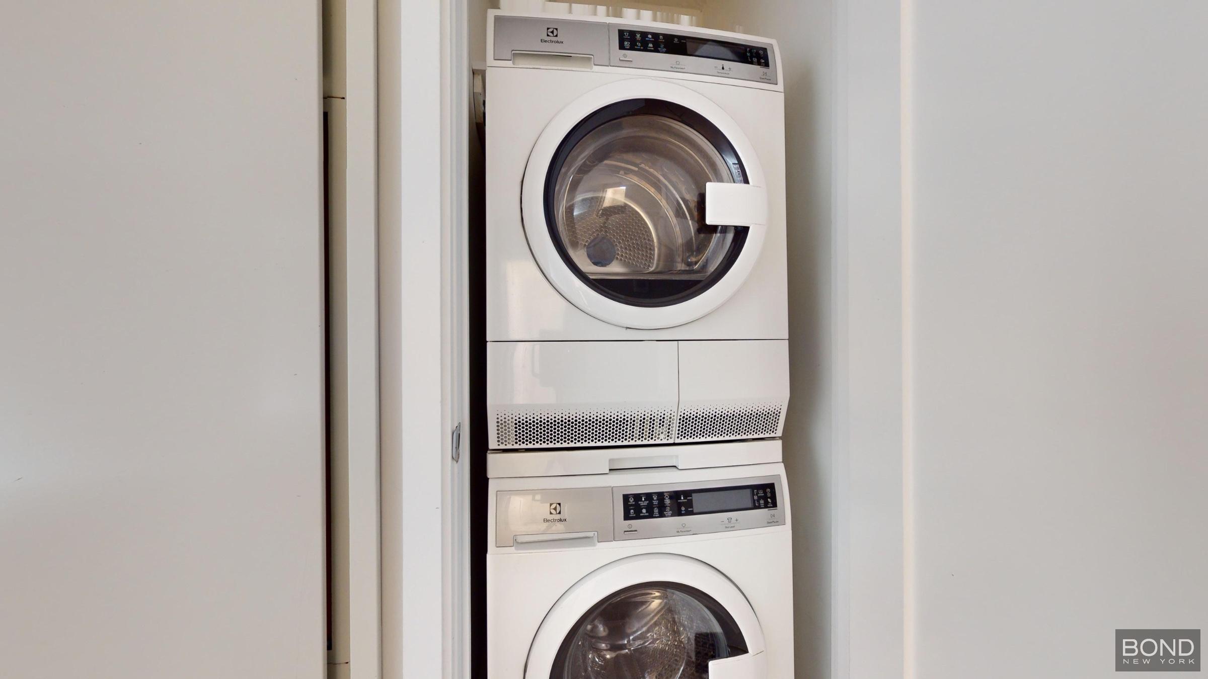 237 East 34th Street, Unit 1503 Manhattan, NY 10016 - Photo 15 of 24 a close up view of a washer and dryer