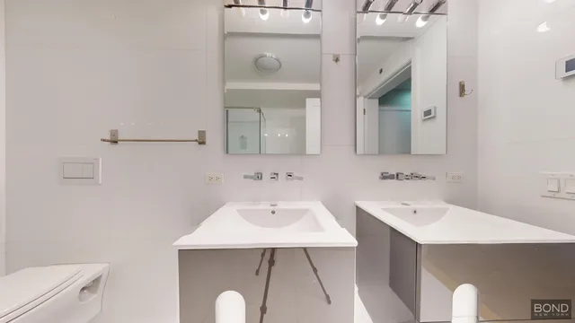 a bathroom with a sink a toilet and mirror