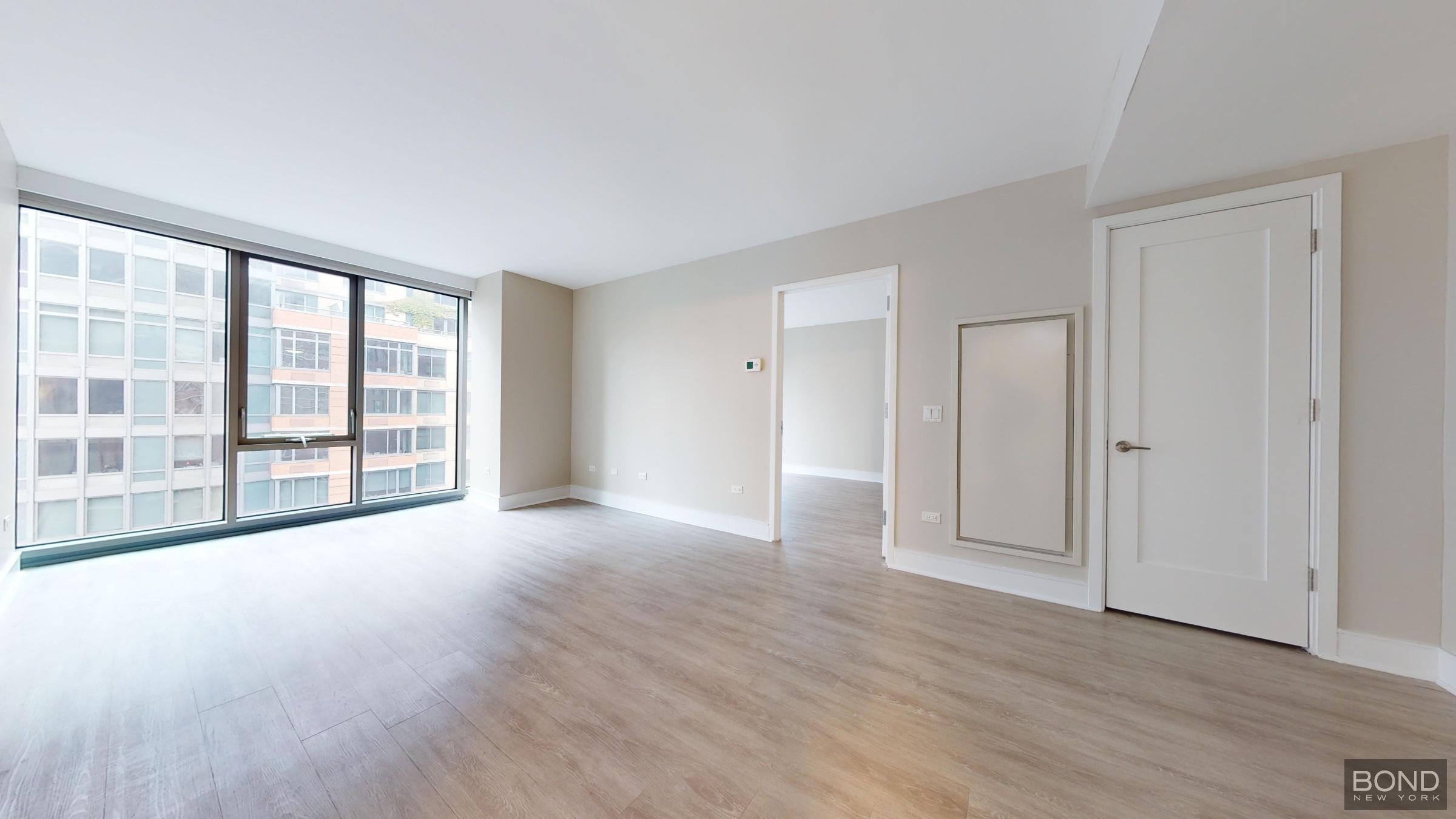 237 East 34th Street, Unit 1503 Manhattan, NY 10016 - Photo 10 of 24 a view of empty room with wooden floor and fan