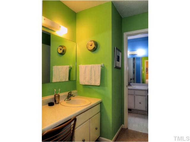6375 New Market Way Raleigh, NC 27615 - Photo 14 of 20 a bathroom with a sink and a mirror