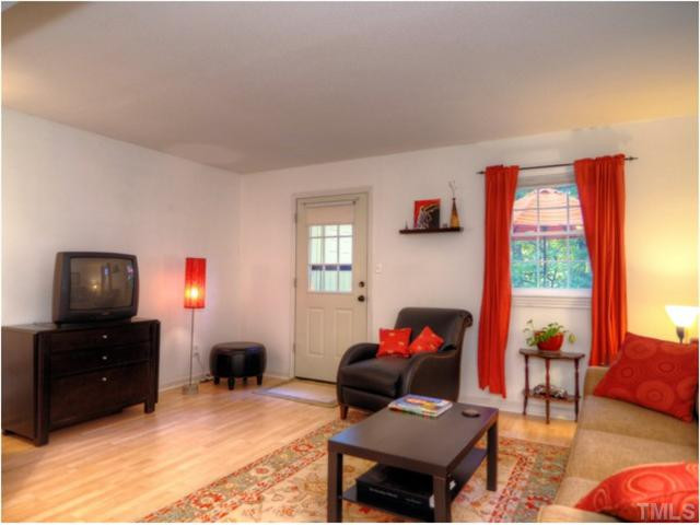 6375 New Market Way Raleigh, NC 27615 - Photo 8 of 20 a living room with furniture and a flat screen tv