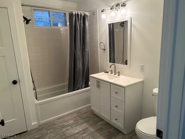 a bathroom with a double vanity sink mirror and shower