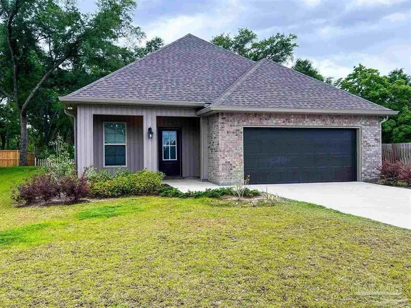 a front view of a house with yard and garage