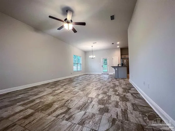 a view of a livingroom with a ceiling fan and window