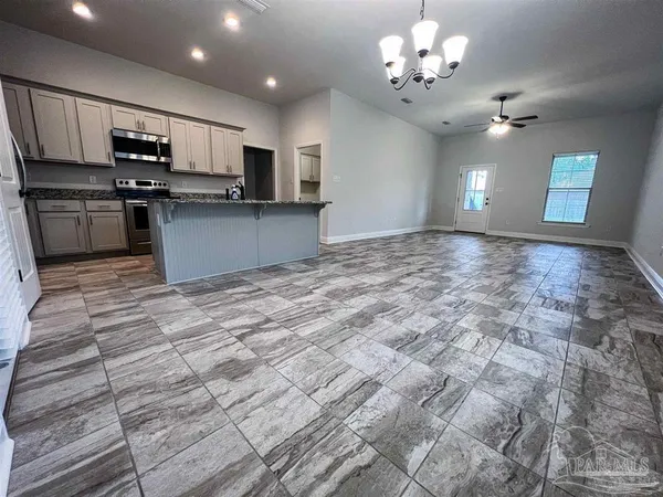 a view of kitchen with sink microwave and cabinets