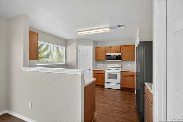a kitchen with stainless steel appliances granite countertop a stove and a refrigerator